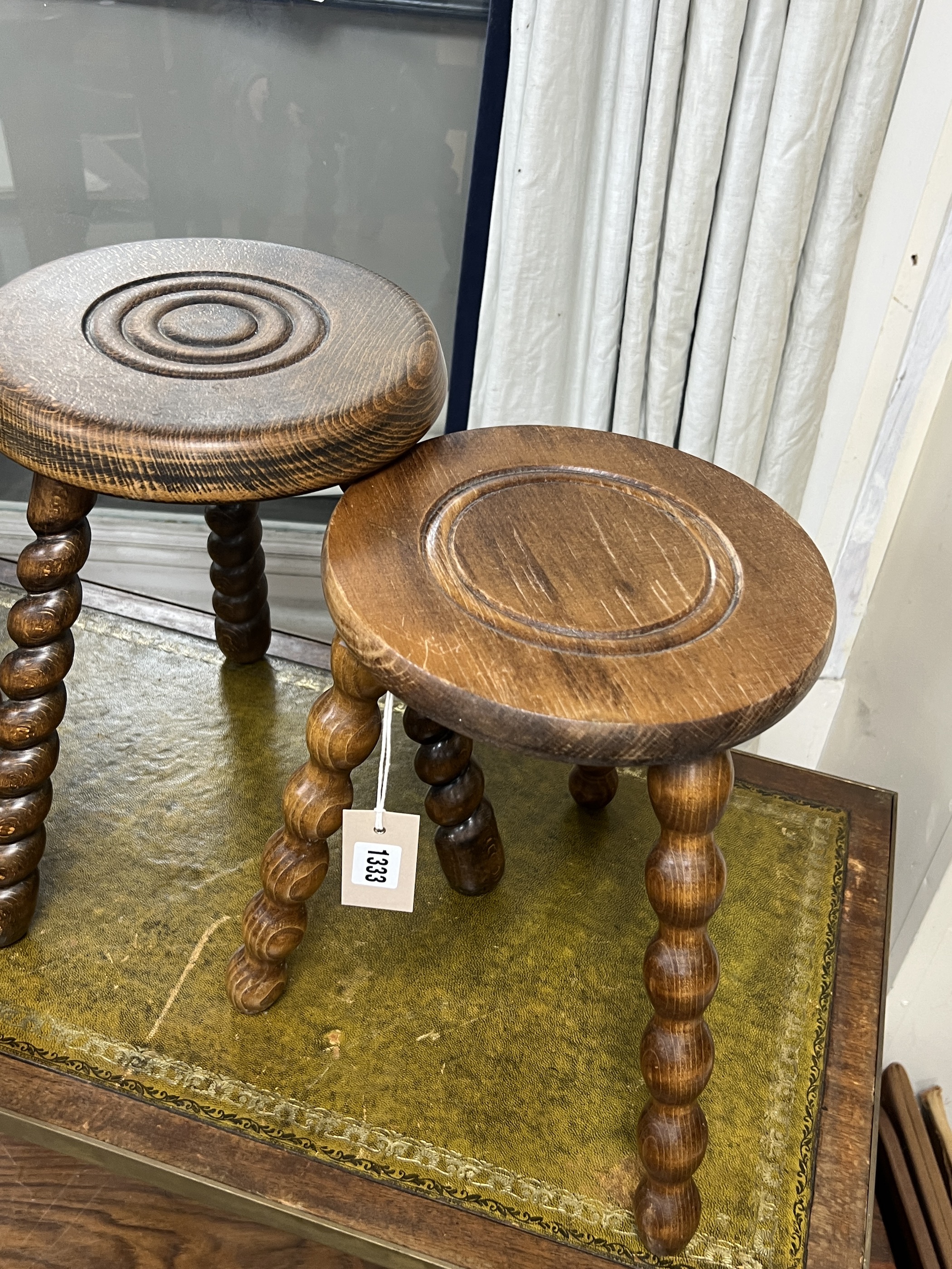 Four assorted French milking stools, largest width 24cm, height 39cm